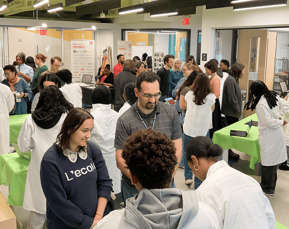 FirstHand students showcase their designs to an adult audience at a FirstHand Showcase