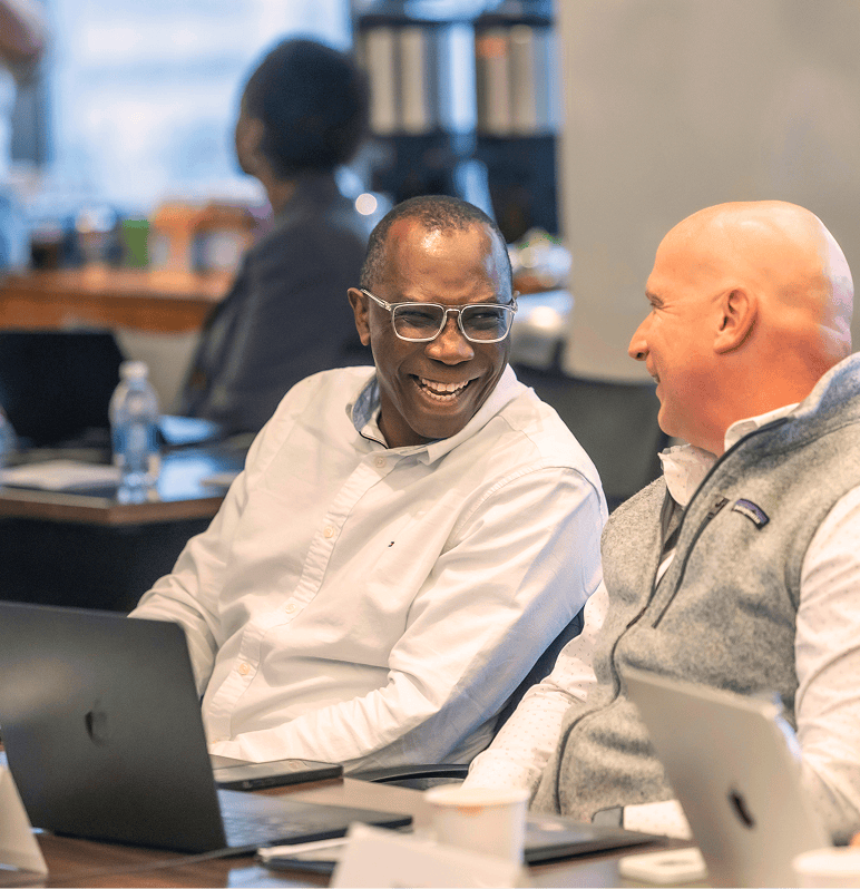 Startup co-founders in Capital Readiness Program exchange smiles