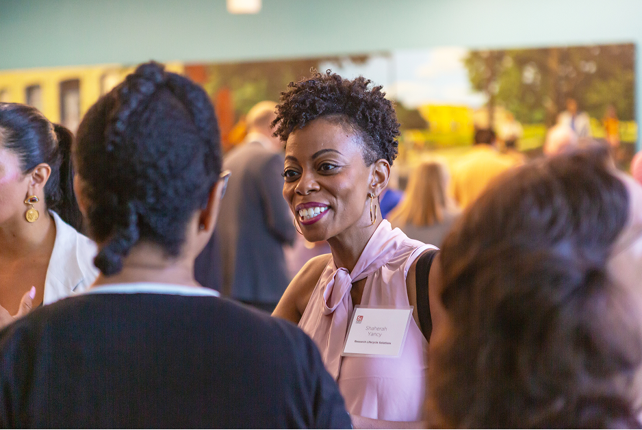 Excited professional woman engages in friendly conversation