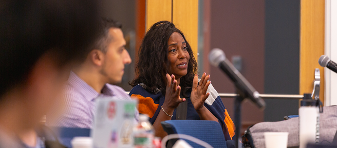 Female founder explains something to person off-camera while gesturing with her hands