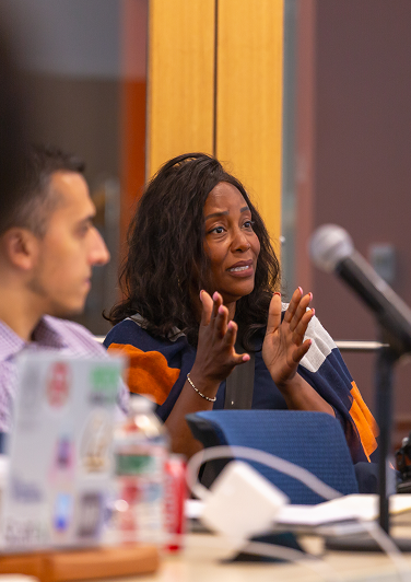 Female founder explains something to person off-camera while gesturing with her hands