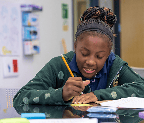 Female student is erasing something with pencil