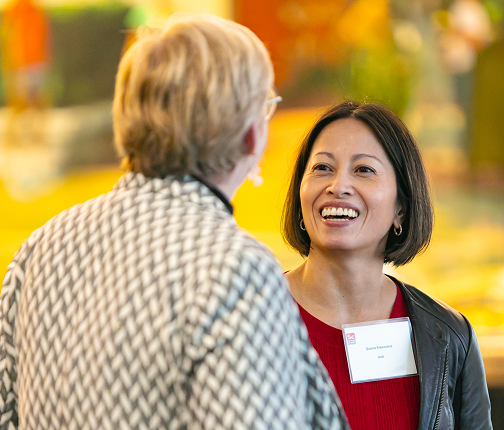 Two professional women in friendly discussion